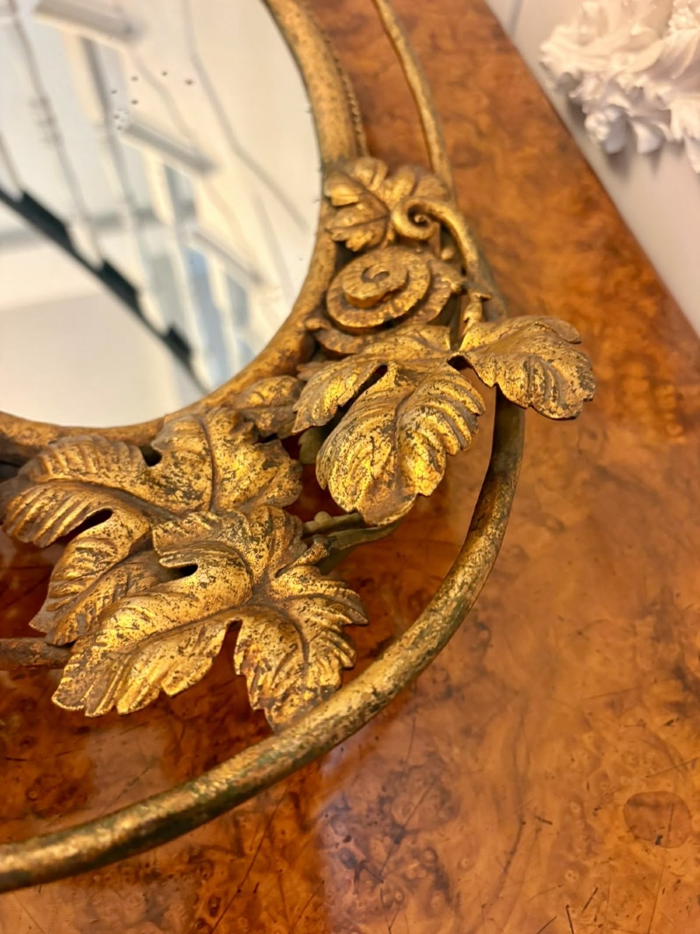 An oval gilt metal tray featuring a central mirror panel surrounded by an ornate border of sculpted grapevines, leaves, and grape clusters. View VIII