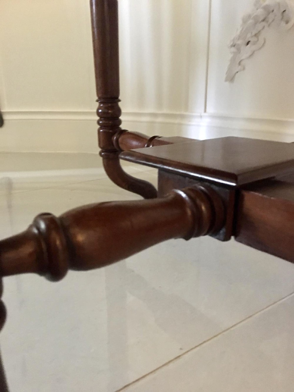 An antique mahogany Sutherland table featuring hinged drop leaves, turned legs with horizontal stretchers, and a central wooden base block. View IV