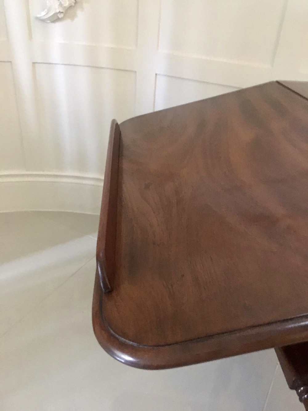 An antique mahogany Sutherland table featuring hinged drop leaves, turned legs with horizontal stretchers, and a central wooden base block. View IX