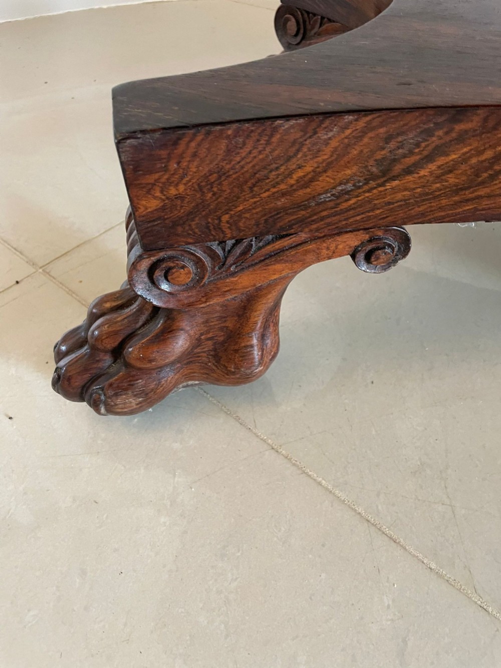 A William IV dark rosewood fold-over card table featuring a gadrooned top edge, scroll carvings, a central pedestal column, and a plinth base on carved claw feet. View IX