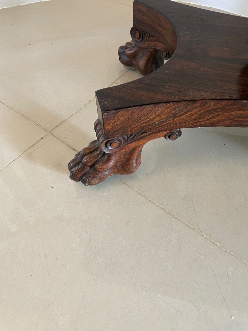 A William IV dark rosewood fold-over card table featuring a gadrooned top edge, scroll carvings, a central pedestal column, and a plinth base on carved claw feet. View XII