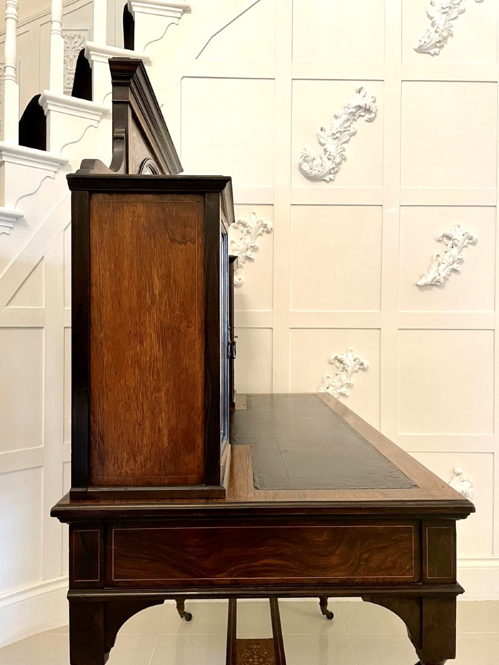 An antique Victorian dark rosewood writing desk featuring decorative floral marquetry inlays, turned legs, and an upper superstructure with twin glazed cabinets and an arched mirror. View III