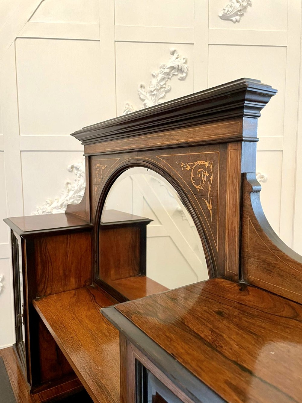 An antique Victorian dark rosewood writing desk featuring decorative floral marquetry inlays, turned legs, and an upper superstructure with twin glazed cabinets and an arched mirror. View IV