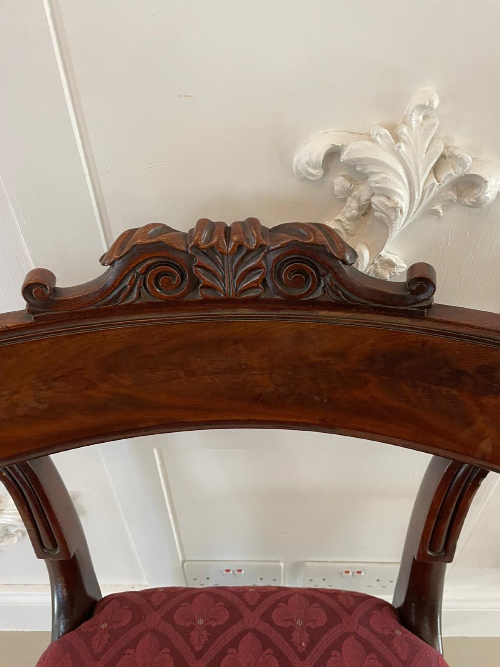 Set of six Regency mahogany library chairs with carved top rails, red patterned upholstered seats, and fluted turned front legs. View III