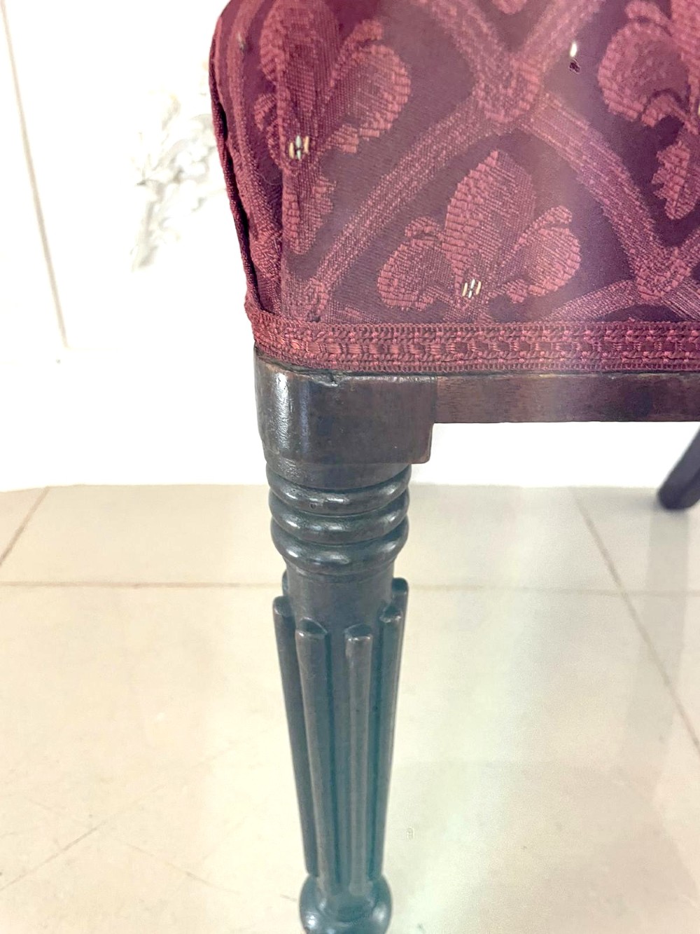 Set of six Regency mahogany library chairs with carved top rails, red patterned upholstered seats, and fluted turned front legs. View V