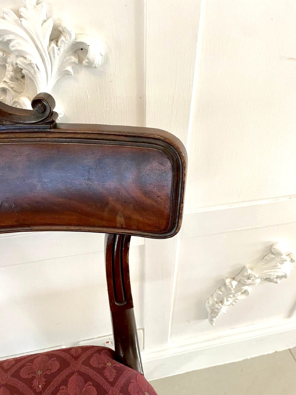 Set of six Regency mahogany library chairs with carved top rails, red patterned upholstered seats, and fluted turned front legs. View VI
