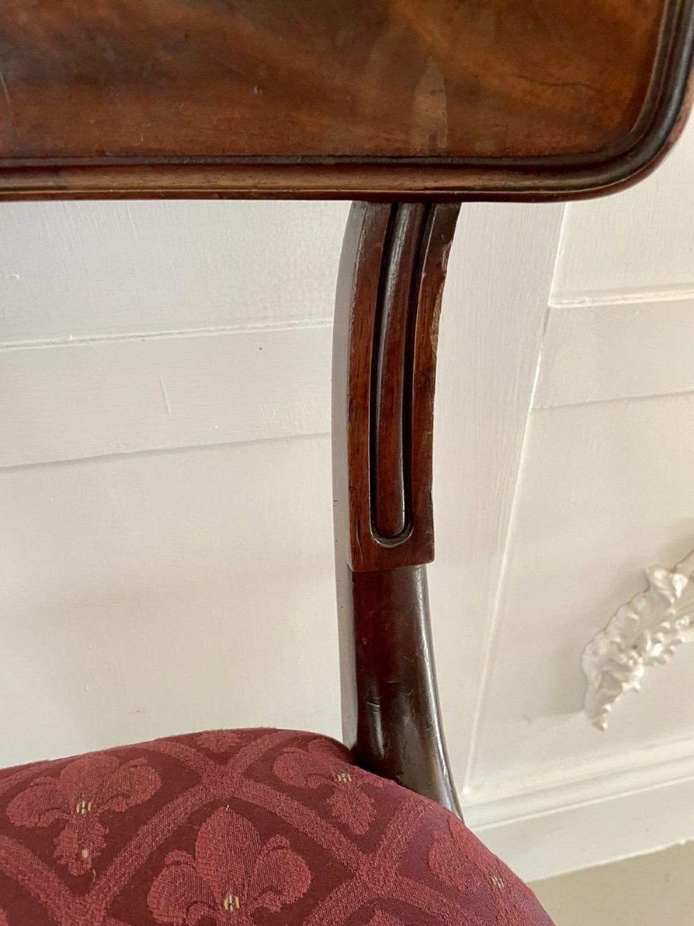 Set of six Regency mahogany library chairs with carved top rails, red patterned upholstered seats, and fluted turned front legs. View VIII