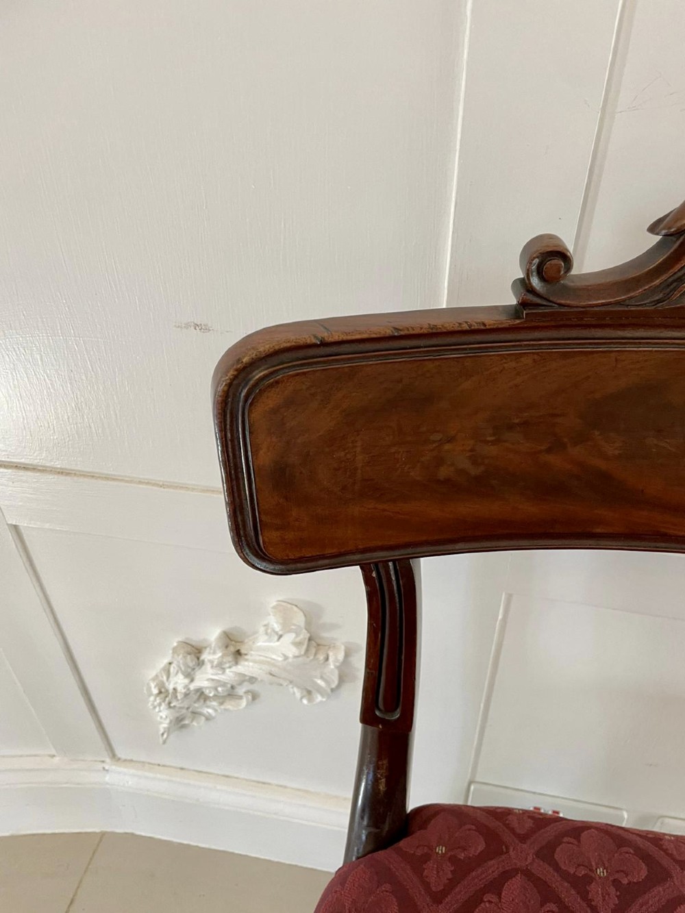 Set of six Regency mahogany library chairs with carved top rails, red patterned upholstered seats, and fluted turned front legs. View IX