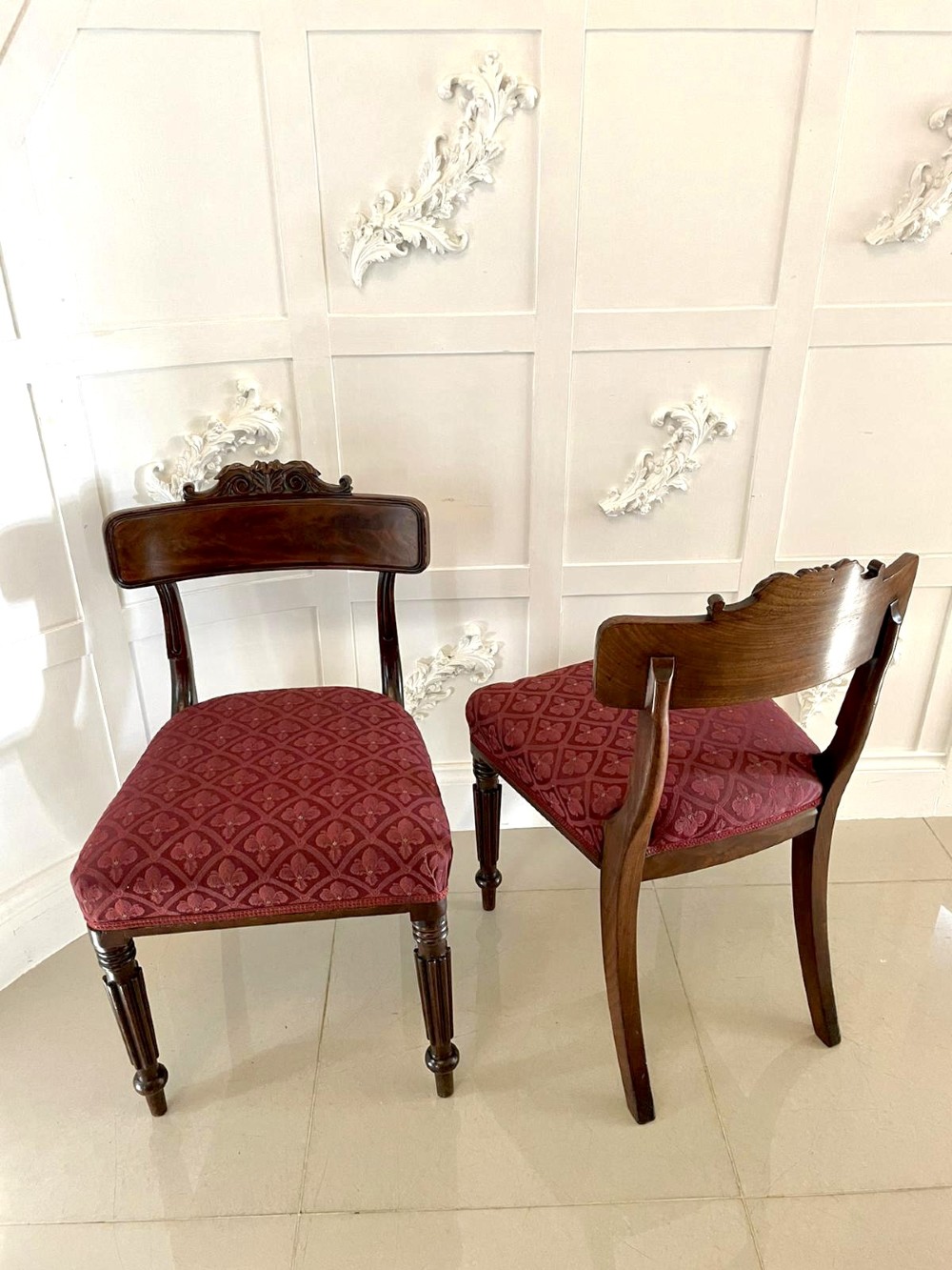 Set of six Regency mahogany library chairs with carved top rails, red patterned upholstered seats, and fluted turned front legs. View X