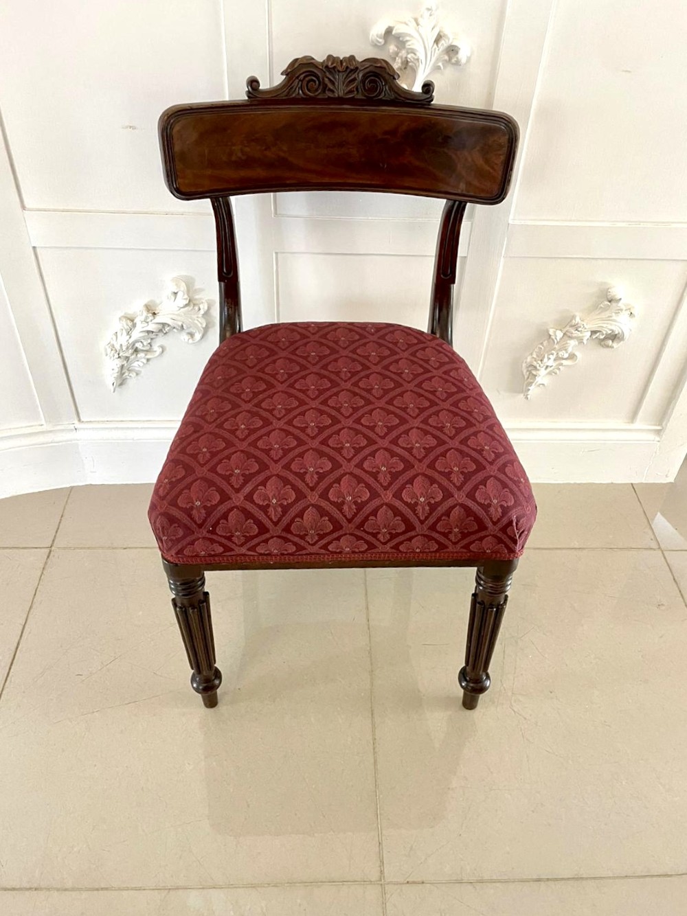 Set of six Regency mahogany library chairs with carved top rails, red patterned upholstered seats, and fluted turned front legs. View XI