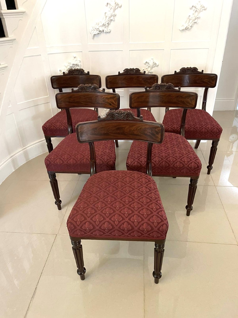 Set of six Regency mahogany library chairs with carved top rails, red patterned upholstered seats, and fluted turned front legs. View XII
