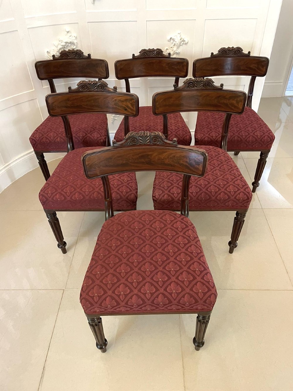 Set of six Regency mahogany library chairs with carved top rails, red patterned upholstered seats, and fluted turned front legs. View XIII