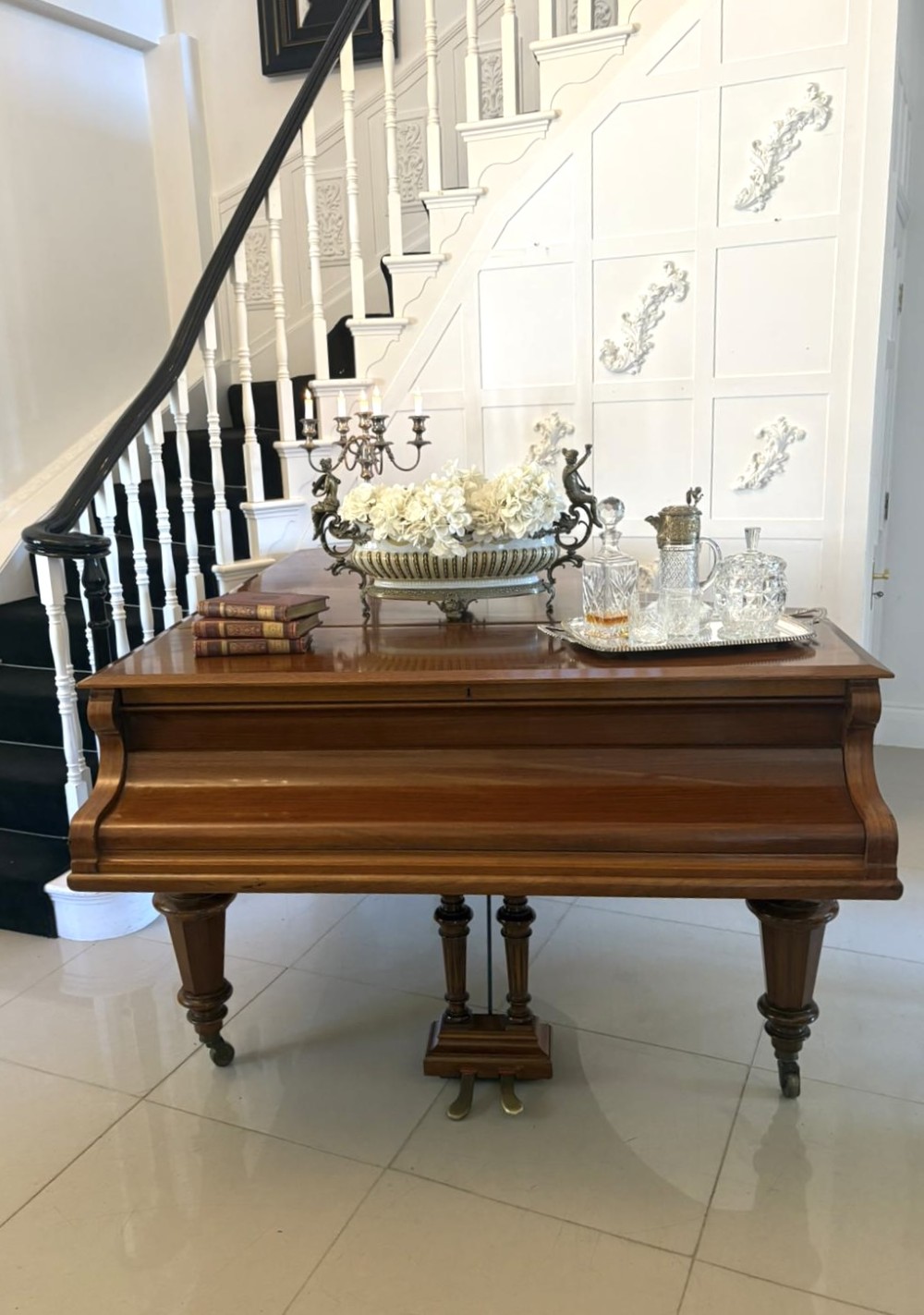 A late Victorian C. Bechstein Model V boudoir grand piano in rosewood, featuring a open top lid, carved fretwork music desk, turned legs, and brass castors. View V