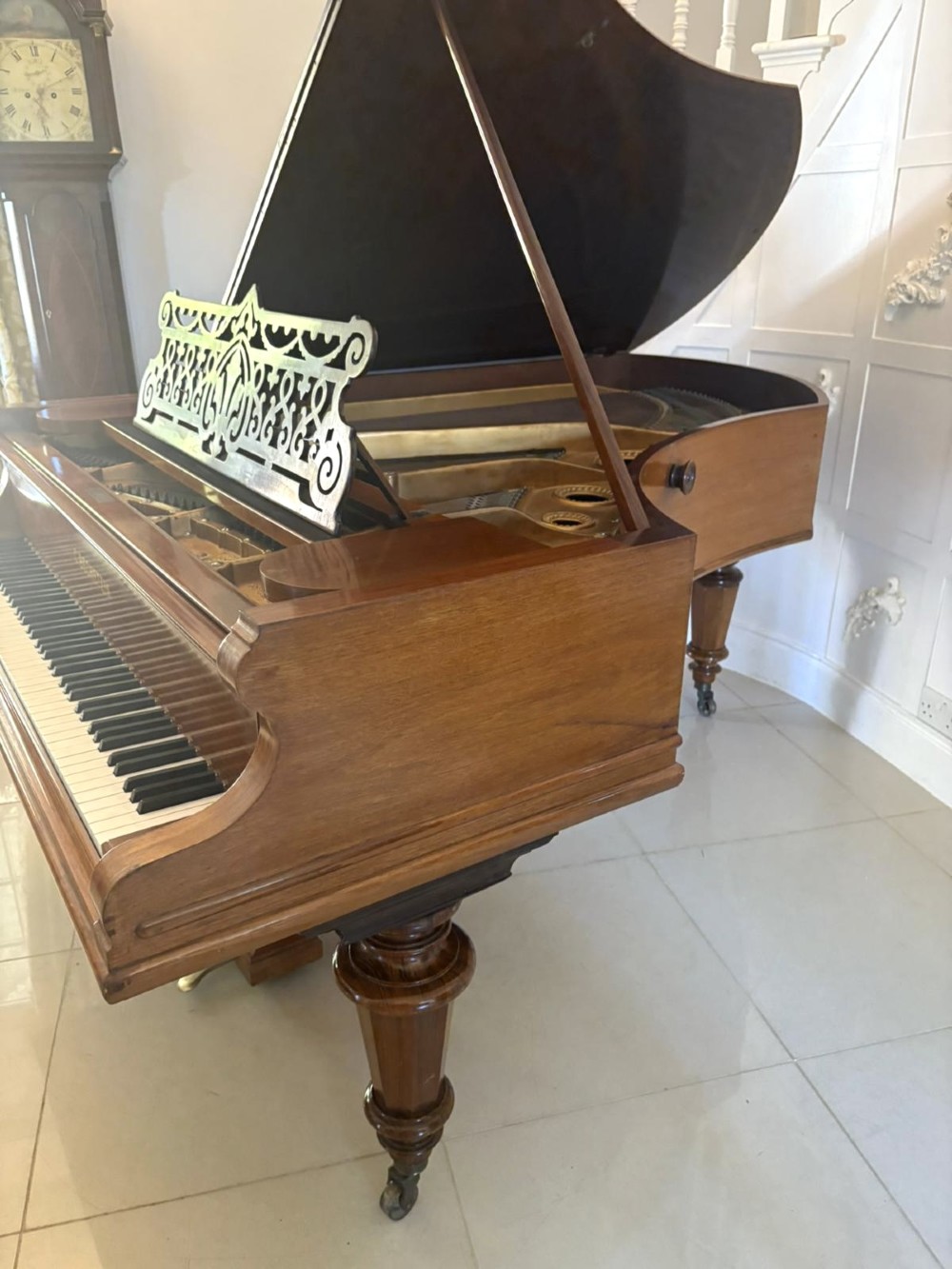 A late Victorian C. Bechstein Model V boudoir grand piano in rosewood, featuring a open top lid, carved fretwork music desk, turned legs, and brass castors. View VIII