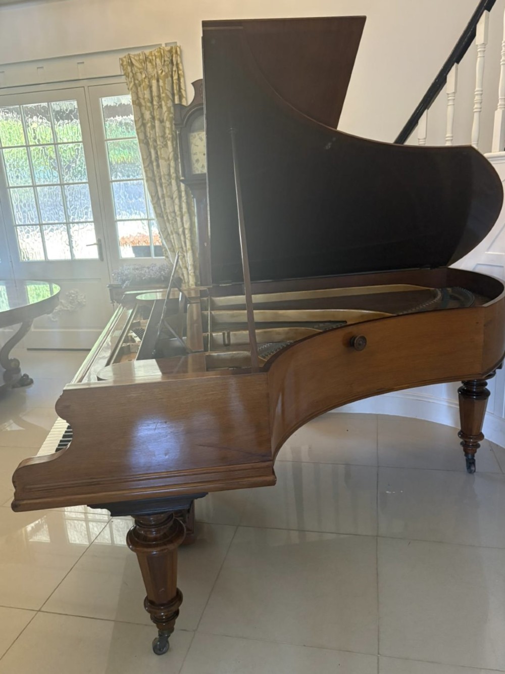 A late Victorian C. Bechstein Model V boudoir grand piano in rosewood, featuring a open top lid, carved fretwork music desk, turned legs, and brass castors. View XII