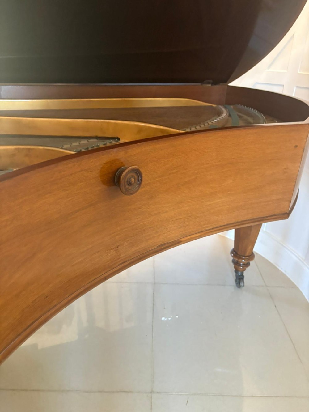A late Victorian C. Bechstein Model V boudoir grand piano in rosewood, featuring a open top lid, carved fretwork music desk, turned legs, and brass castors. View XIII