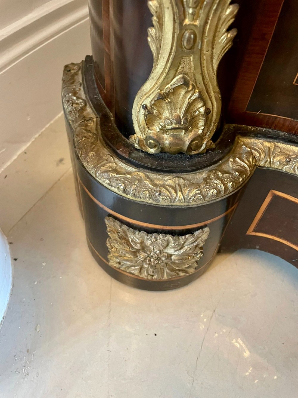 A dark wood Victorian serpentine credenza with floral marquetry inlay, gilt ormolu mounts, and two curved glass display doors. View XI