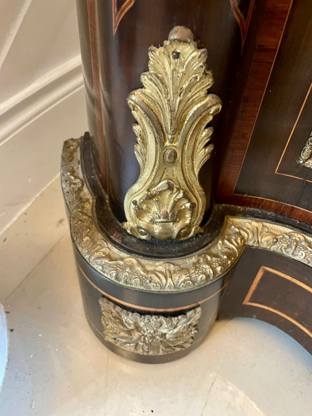 A dark wood Victorian serpentine credenza with floral marquetry inlay, gilt ormolu mounts, and two curved glass display doors. View XIII