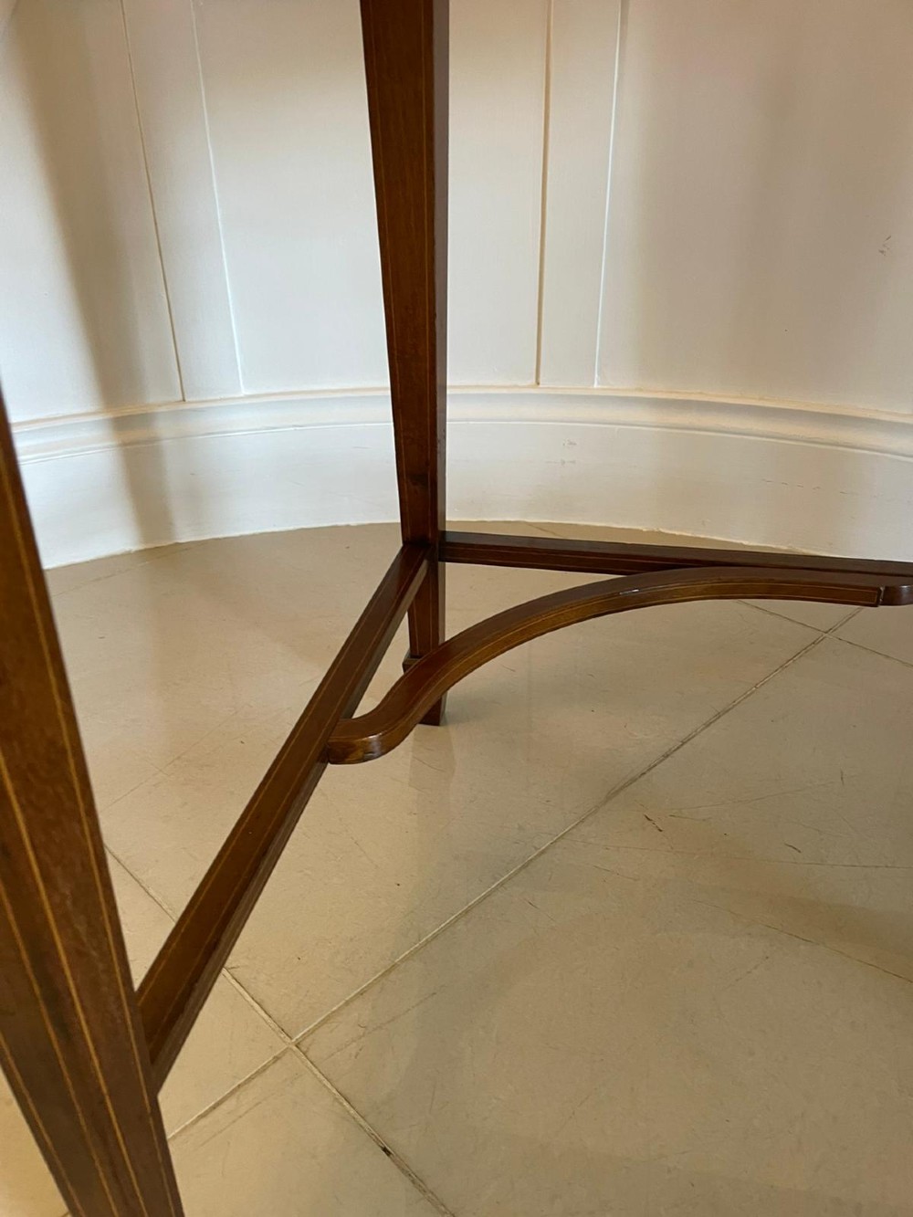 An Edwardian mahogany cylinder writing desk featuring satinwood inlay, brass gallery top rail, and tapered square legs. View II