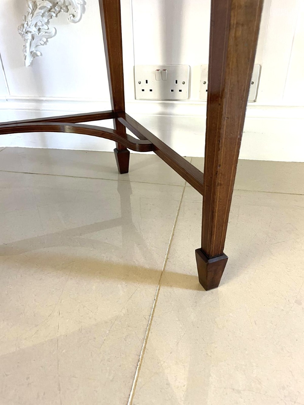 An Edwardian mahogany cylinder writing desk featuring satinwood inlay, brass gallery top rail, and tapered square legs. View XI