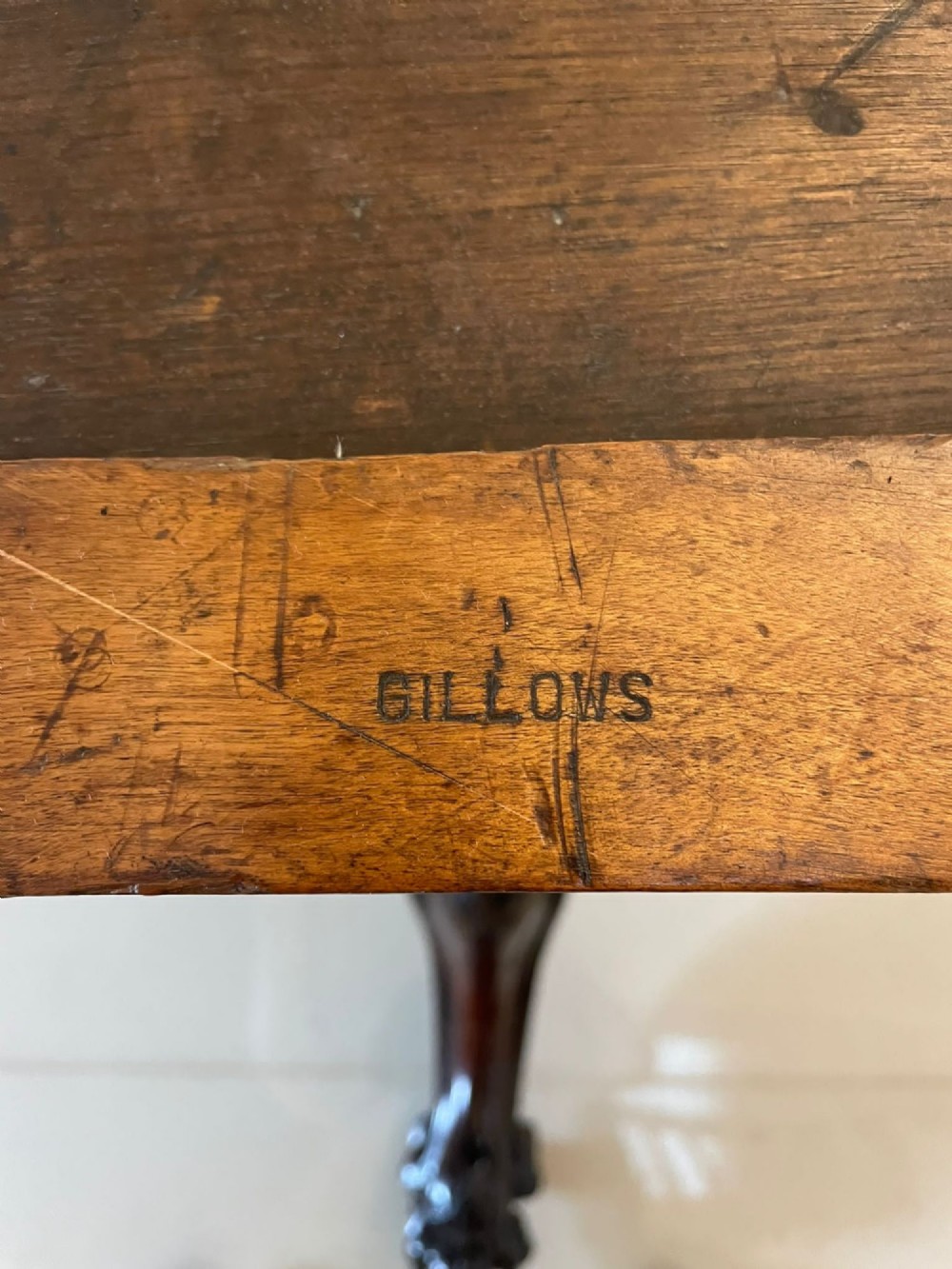 An Early Victorian octagonal rosewood tilt-top centre table with a highly figured grain surface resting on a carved pedestal base with scroll feet. View VIII