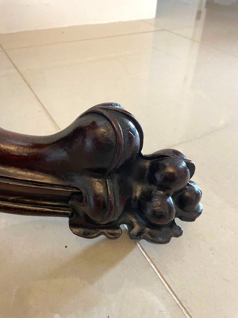 An Early Victorian octagonal rosewood tilt-top centre table with a highly figured grain surface resting on a carved pedestal base with scroll feet. View XII