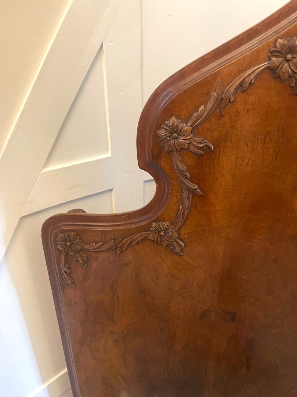 A pair of antique burr walnut single beds featuring high arched headboards, carved shell detailing on the aprons, and scroll-topped footposts. View II