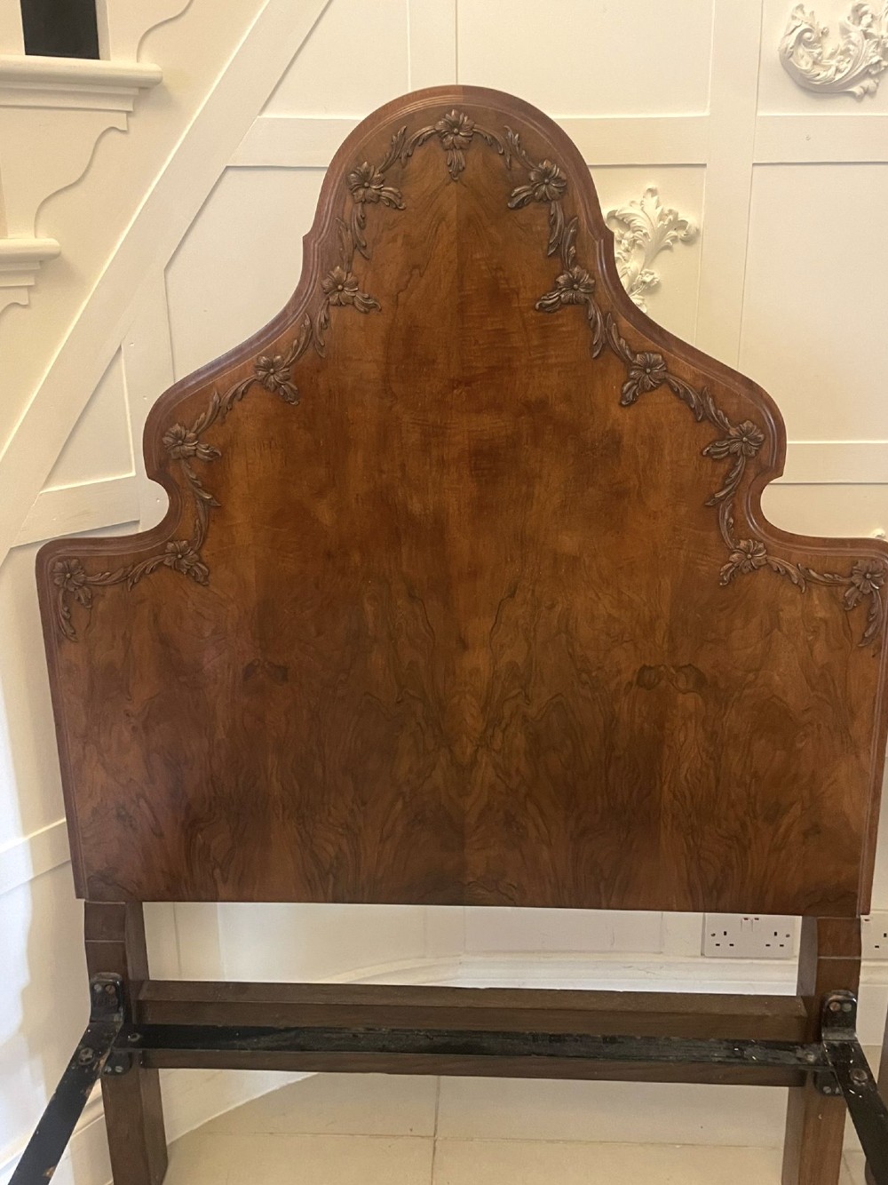 A pair of antique burr walnut single beds featuring high arched headboards, carved shell detailing on the aprons, and scroll-topped footposts. View VI