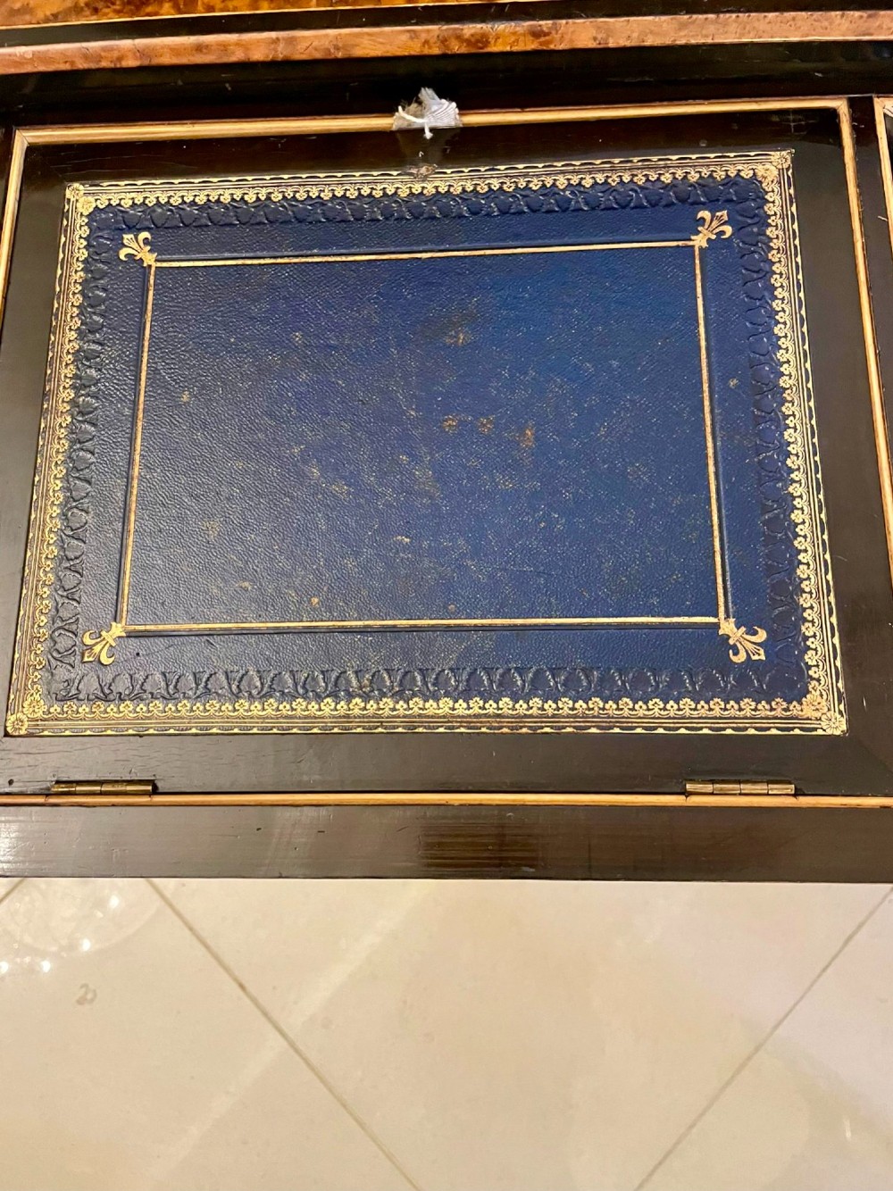 A Victorian ebonised writing desk featuring burr walnut inlaid panels, central oval marquetry medallions, and a pierced brass gallery along the top. View II
