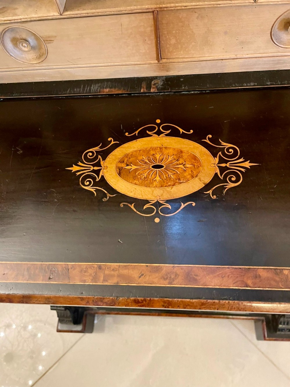 A Victorian ebonised writing desk featuring burr walnut inlaid panels, central oval marquetry medallions, and a pierced brass gallery along the top. View VIII