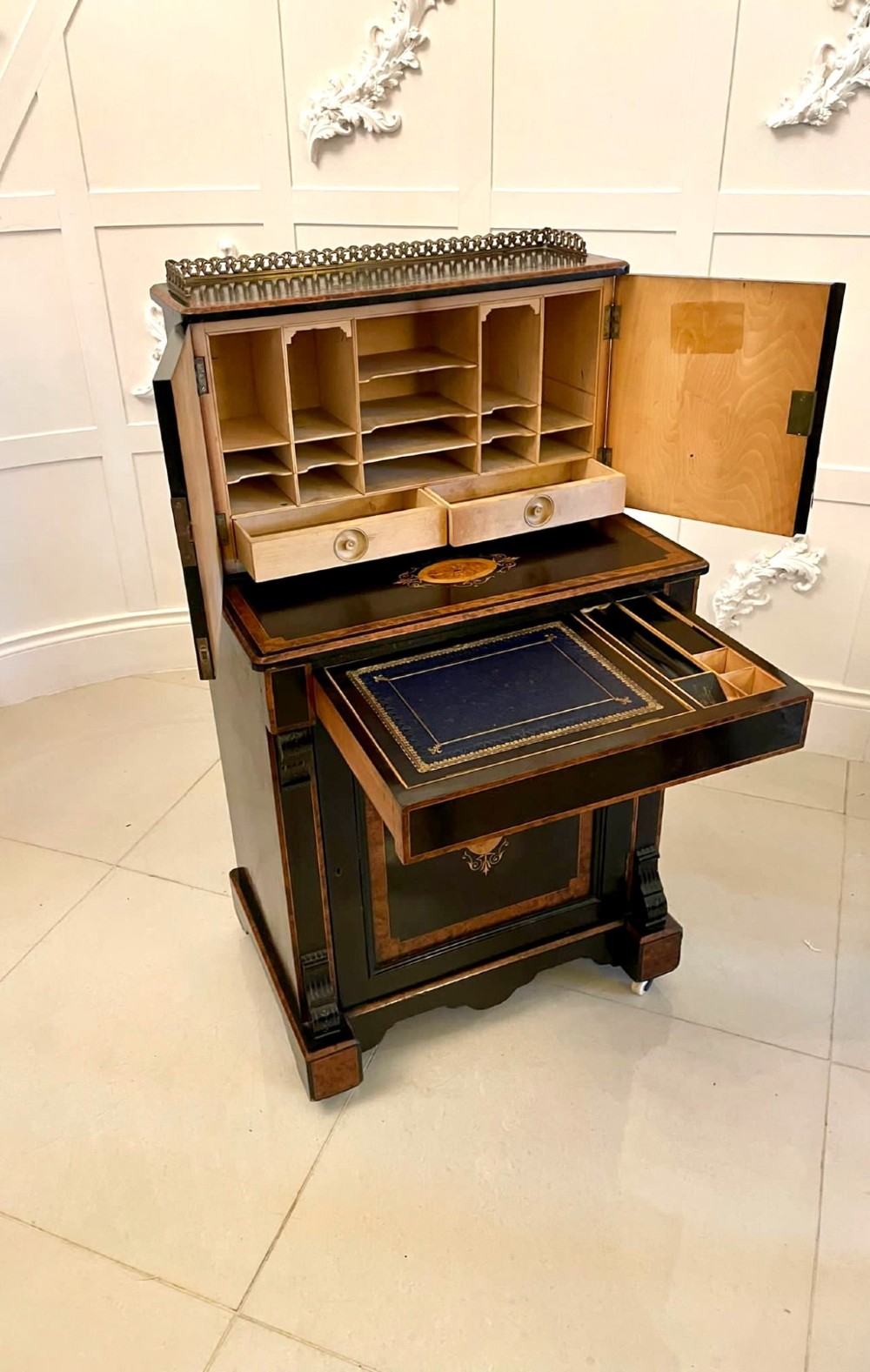 A Victorian ebonised writing desk featuring burr walnut inlaid panels, central oval marquetry medallions, and a pierced brass gallery along the top. View XI