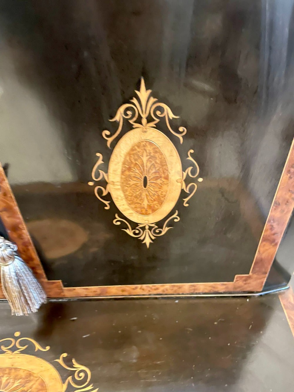 A Victorian ebonised writing desk featuring burr walnut inlaid panels, central oval marquetry medallions, and a pierced brass gallery along the top. View XII