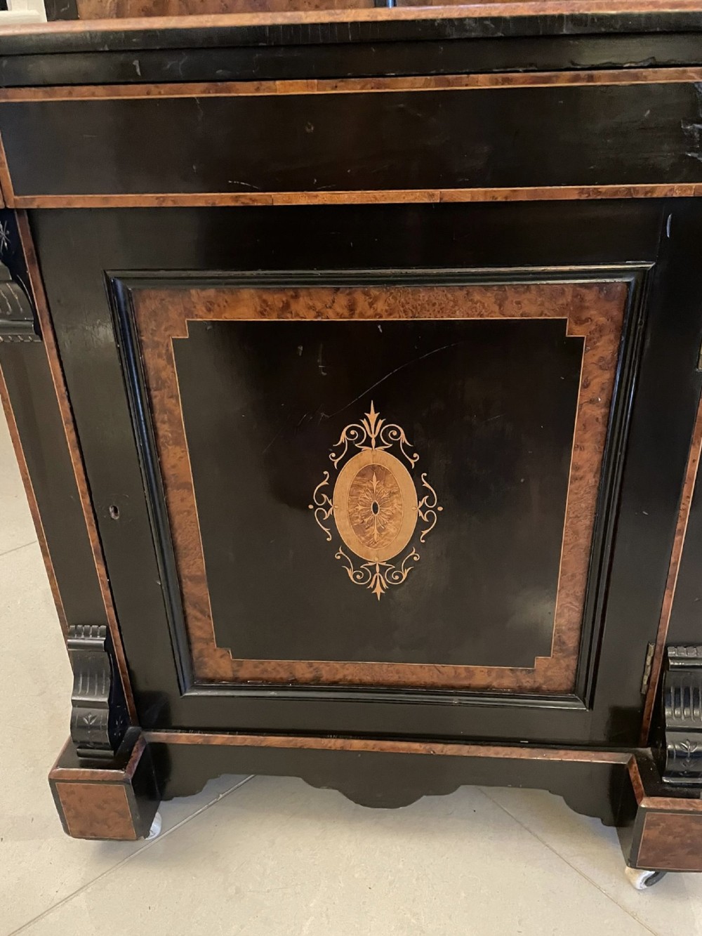 A Victorian ebonised writing desk featuring burr walnut inlaid panels, central oval marquetry medallions, and a pierced brass gallery along the top. View XIII
