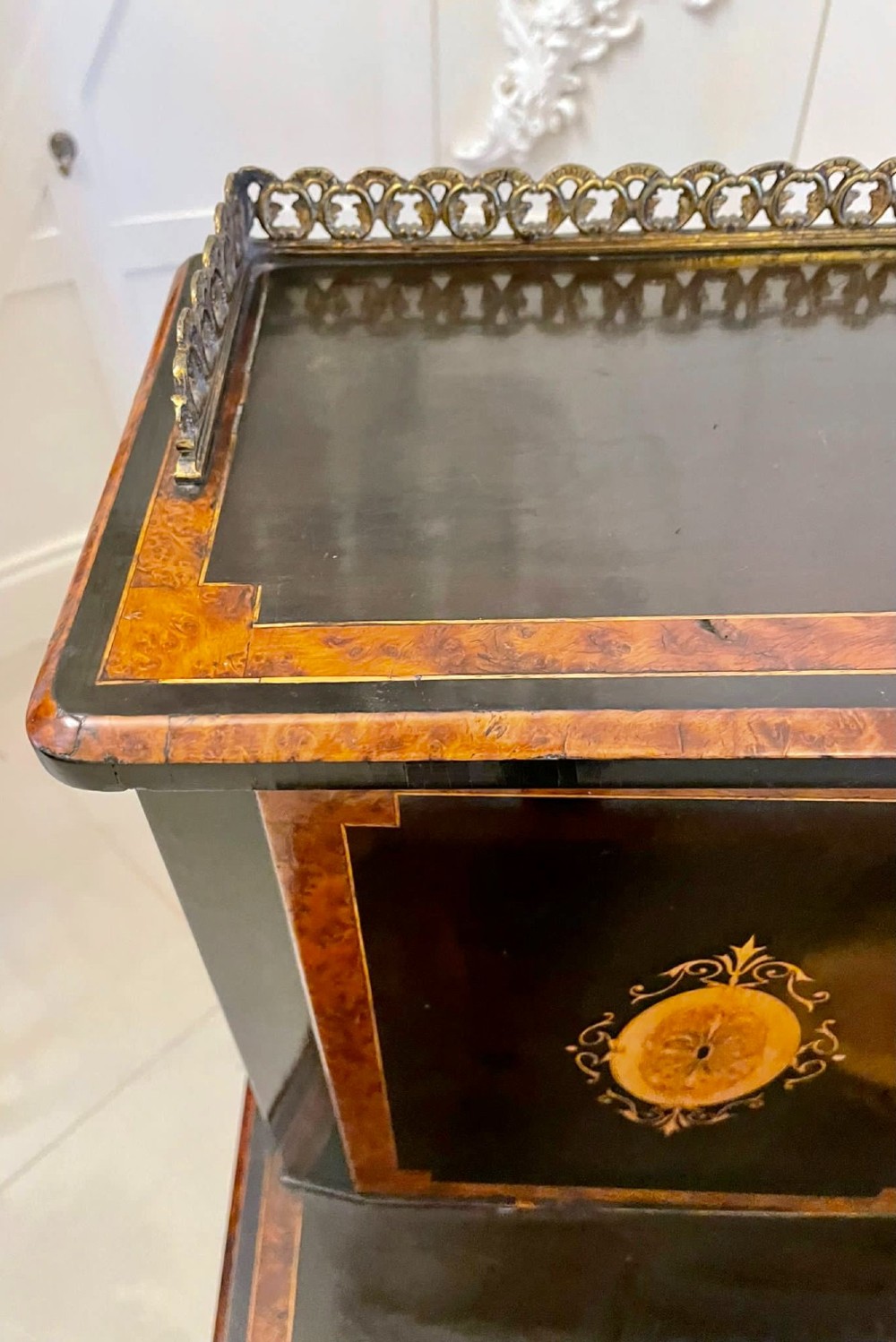 A Victorian ebonised writing desk featuring burr walnut inlaid panels, central oval marquetry medallions, and a pierced brass gallery along the top. View XIV