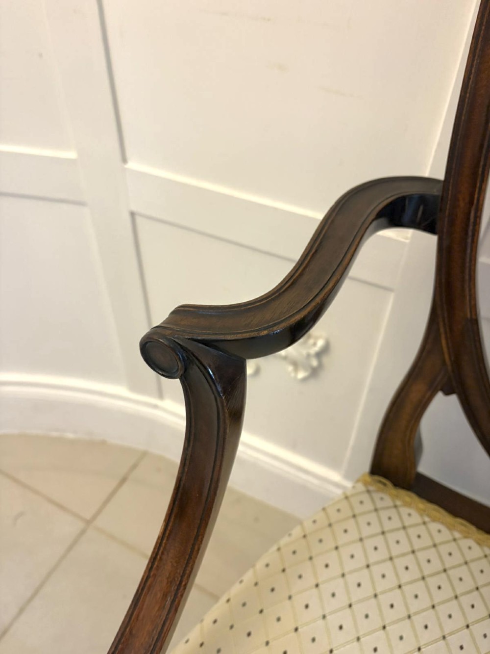 A set of ten antique Edwardian mahogany dining chairs featuring carved shield-shaped backrests and light cream upholstered seats. View V