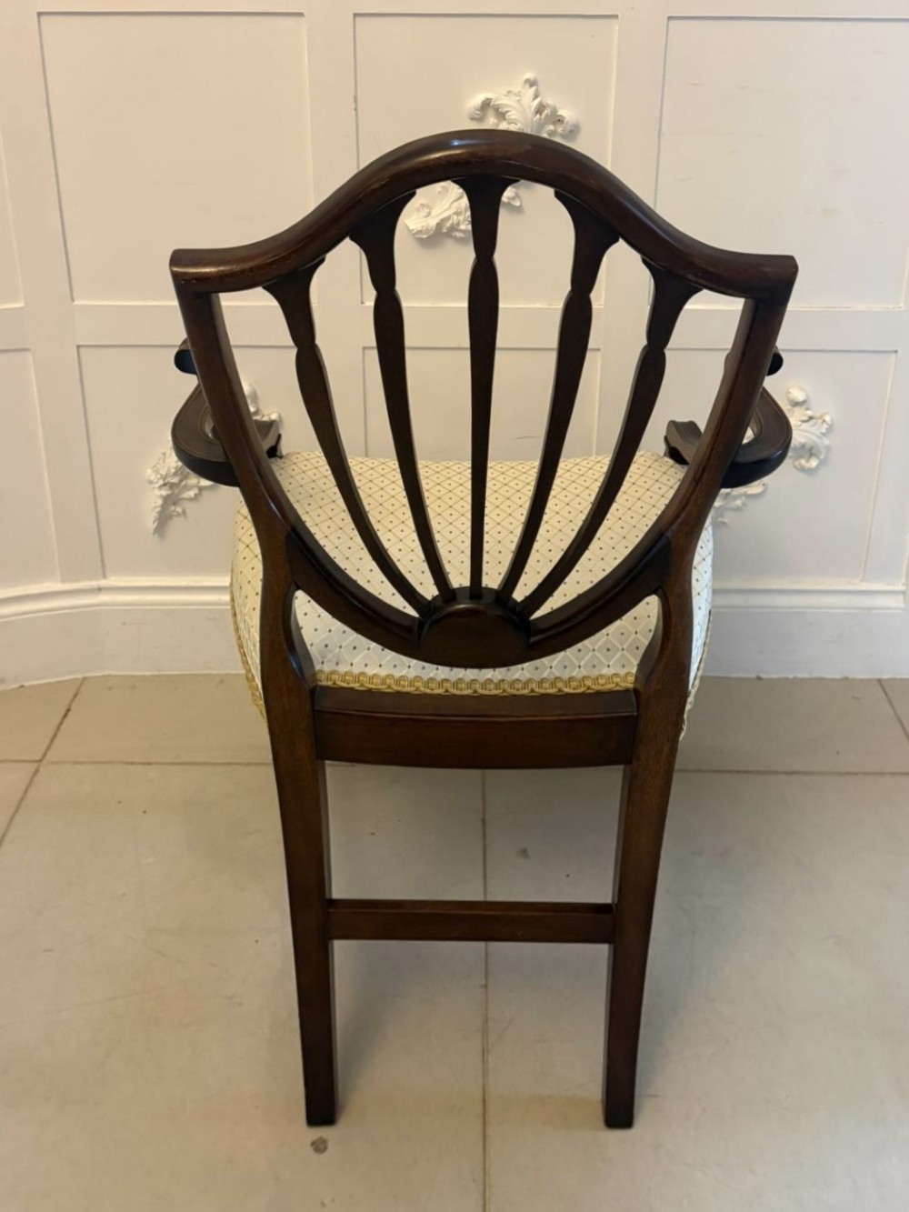 A set of ten antique Edwardian mahogany dining chairs featuring carved shield-shaped backrests and light cream upholstered seats. View VI