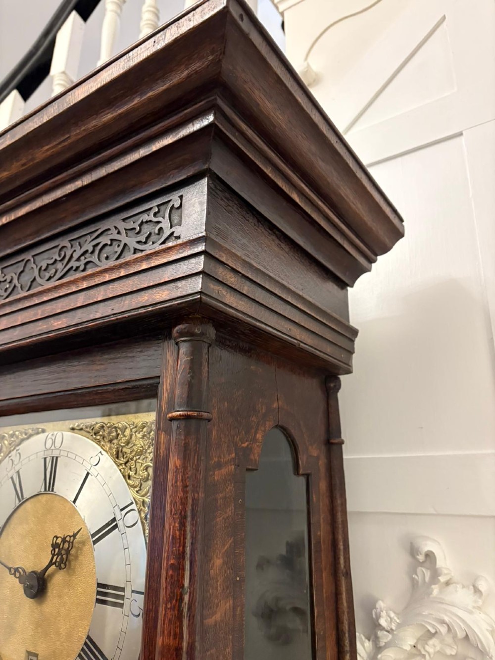 A George III oak and burr oak longcase clock featuring a square brass dial, fretwork hood frieze, and a long waist door. View V