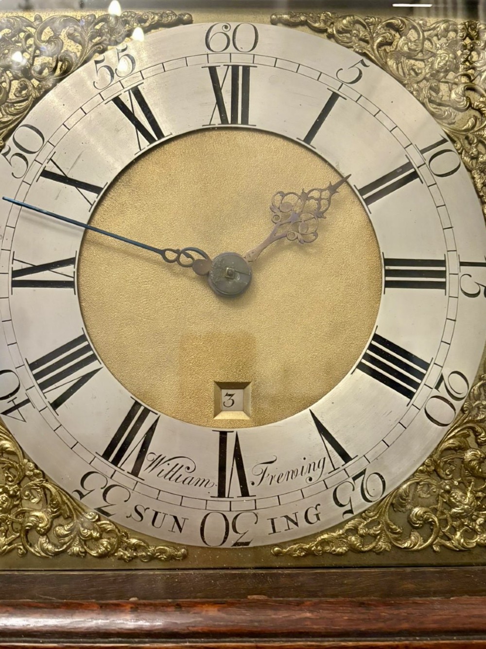 A George III oak and burr oak longcase clock featuring a square brass dial, fretwork hood frieze, and a long waist door. View VI