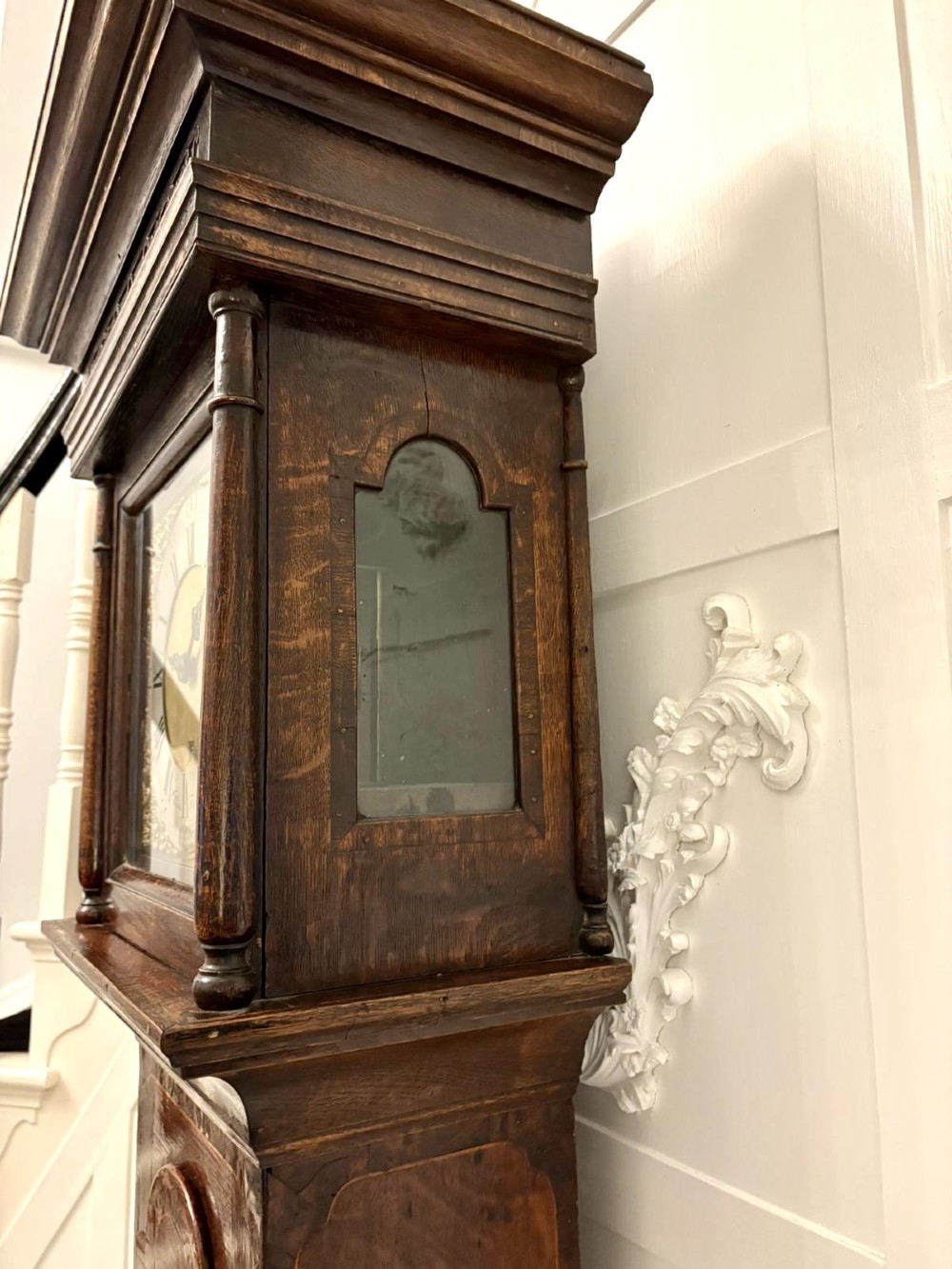 A George III oak and burr oak longcase clock featuring a square brass dial, fretwork hood frieze, and a long waist door. View VII