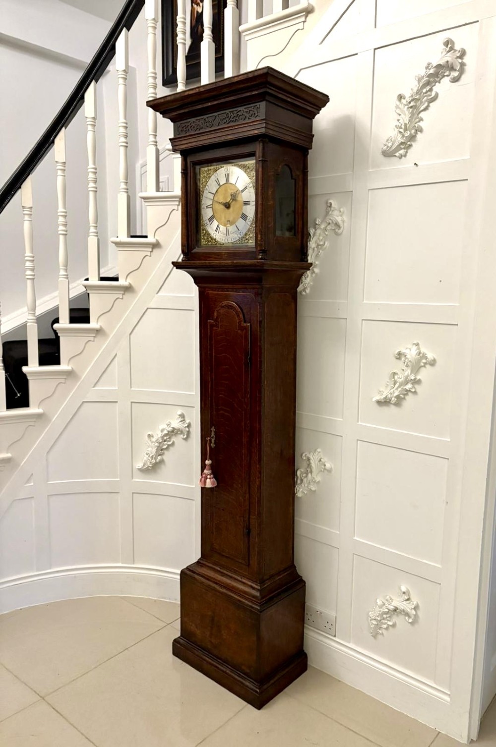 A George III oak and burr oak longcase clock featuring a square brass dial, fretwork hood frieze, and a long waist door. View X