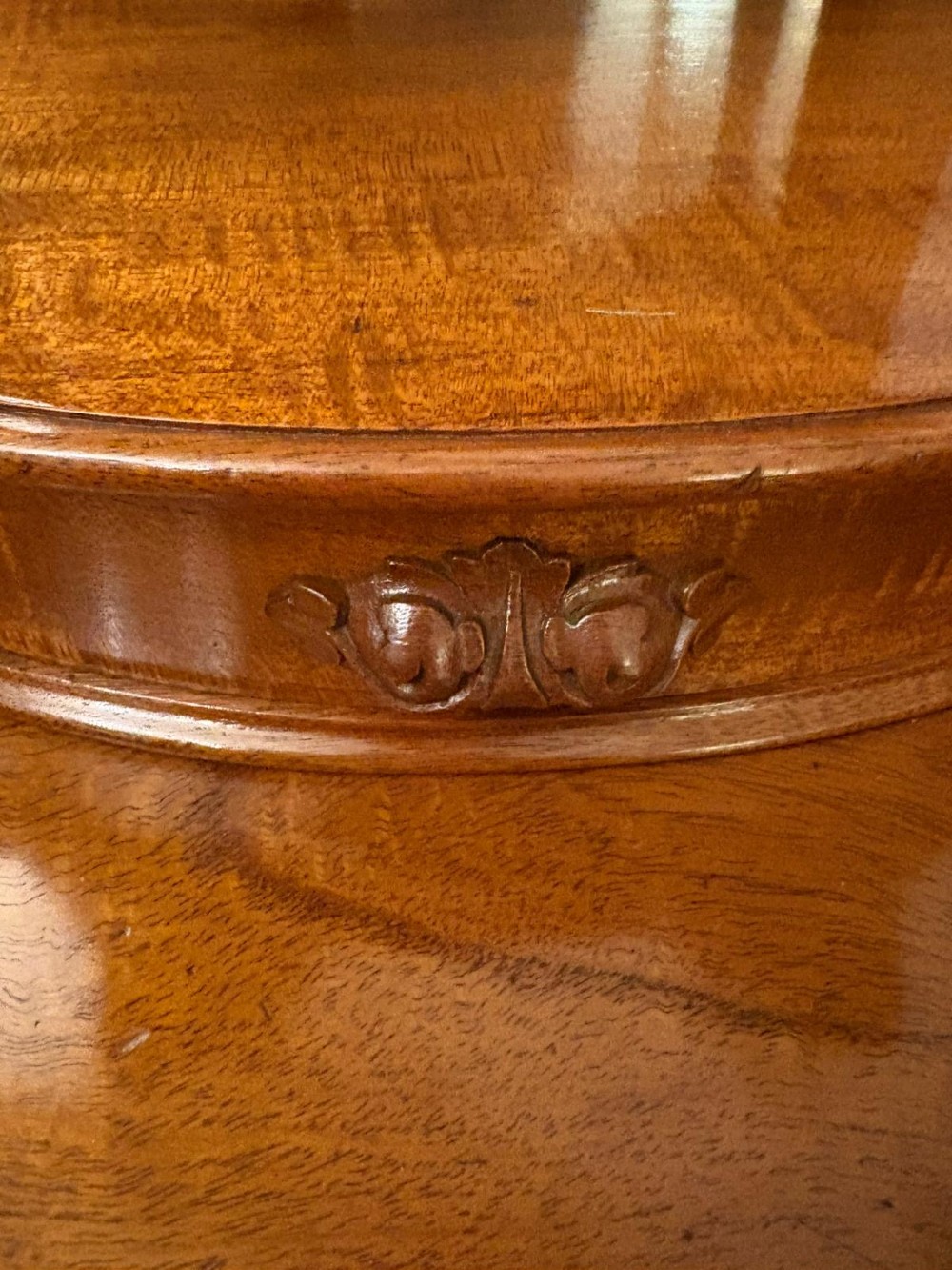 An antique Victorian carved mahogany dressing table featuring an arched swivel mirror, twin trinket drawers, turned front columns, and a shaped lower shelf. View VII