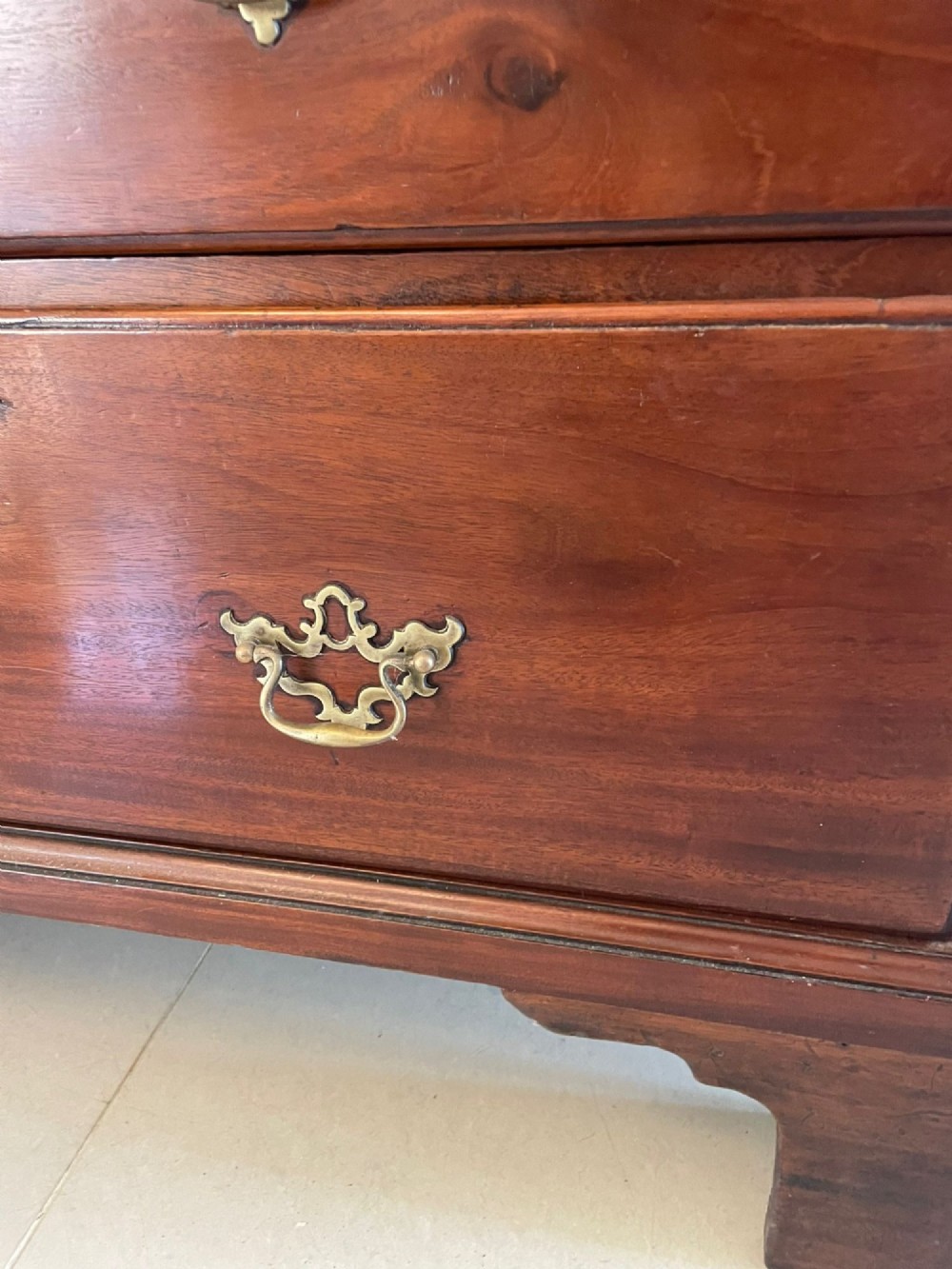 An antique George III mahogany chest on chest featuring two short and three long drawers on the upper section over three long drawers on bracket feet. View III