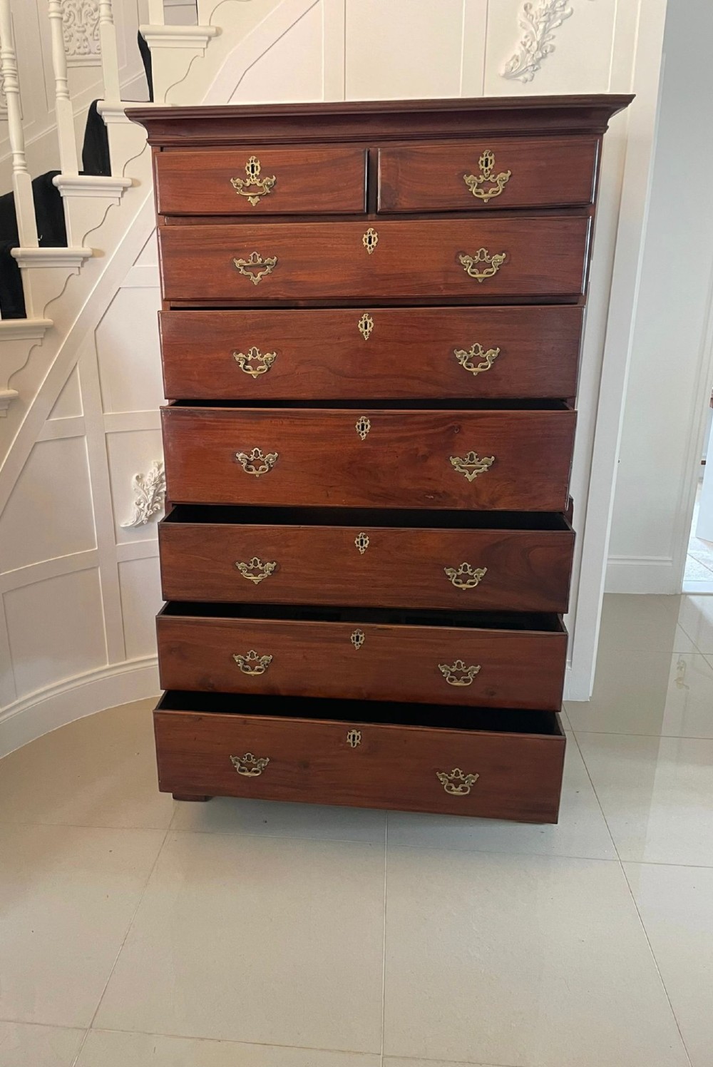 An antique George III mahogany chest on chest featuring two short and three long drawers on the upper section over three long drawers on bracket feet. View IV