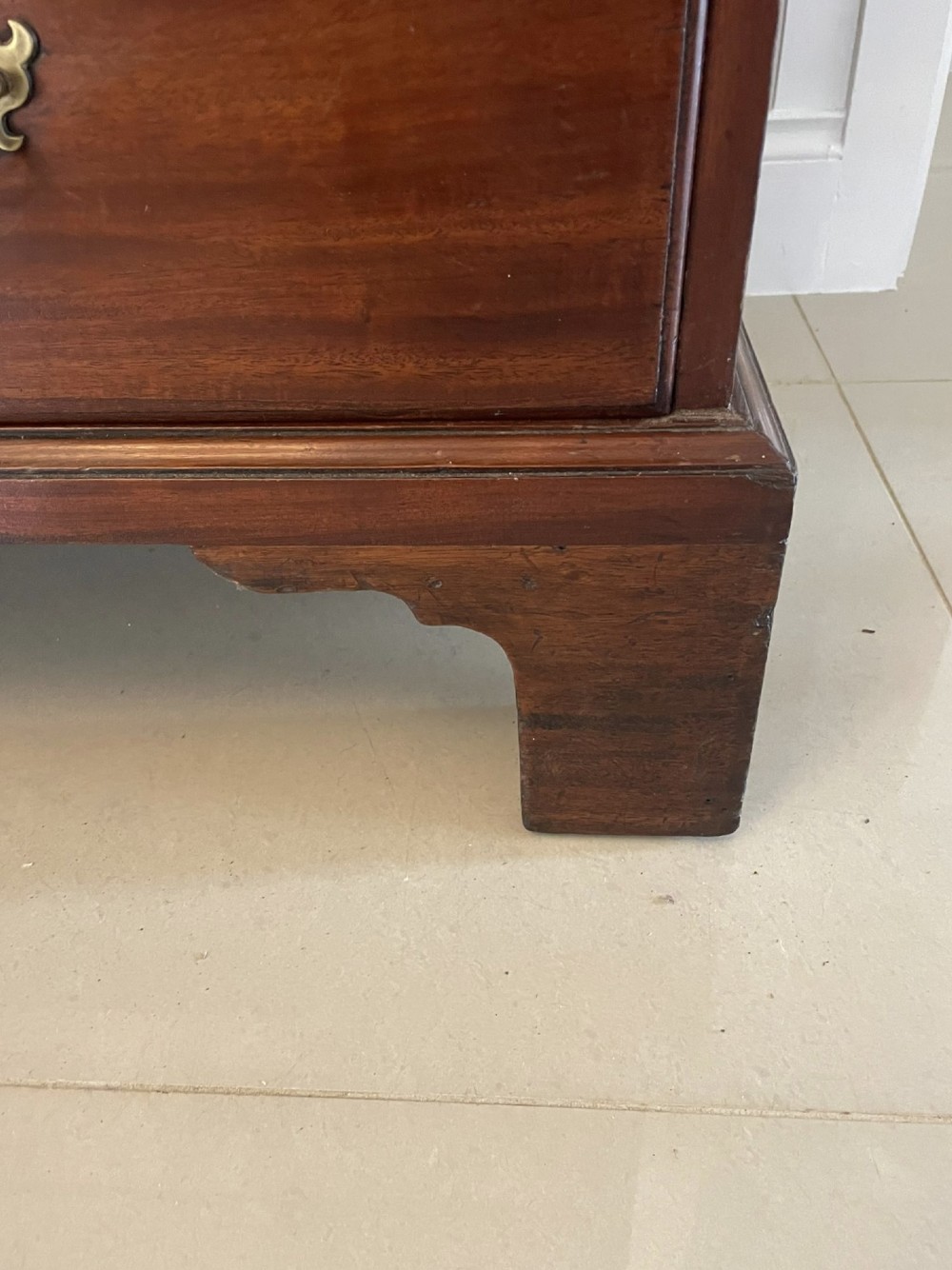 An antique George III mahogany chest on chest featuring two short and three long drawers on the upper section over three long drawers on bracket feet. View V