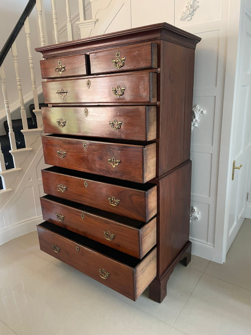An antique George III mahogany chest on chest featuring two short and three long drawers on the upper section over three long drawers on bracket feet. View VI