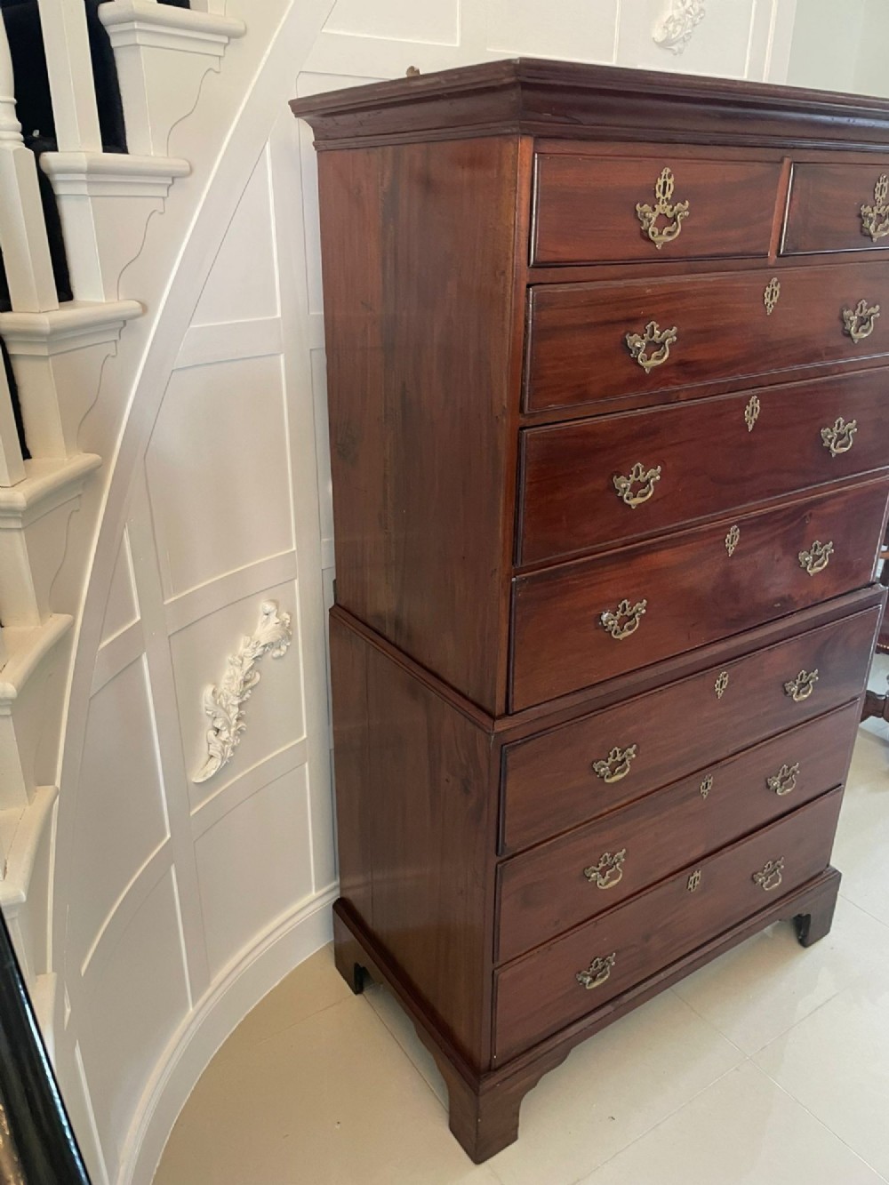 An antique George III mahogany chest on chest featuring two short and three long drawers on the upper section over three long drawers on bracket feet. View VIII