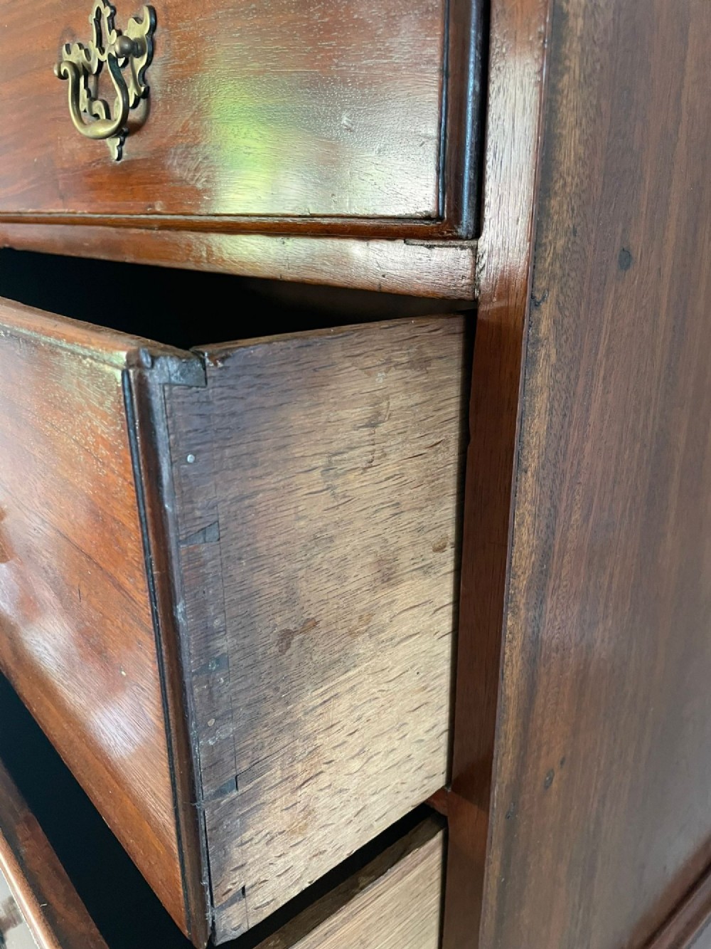 An antique George III mahogany chest on chest featuring two short and three long drawers on the upper section over three long drawers on bracket feet. View IX