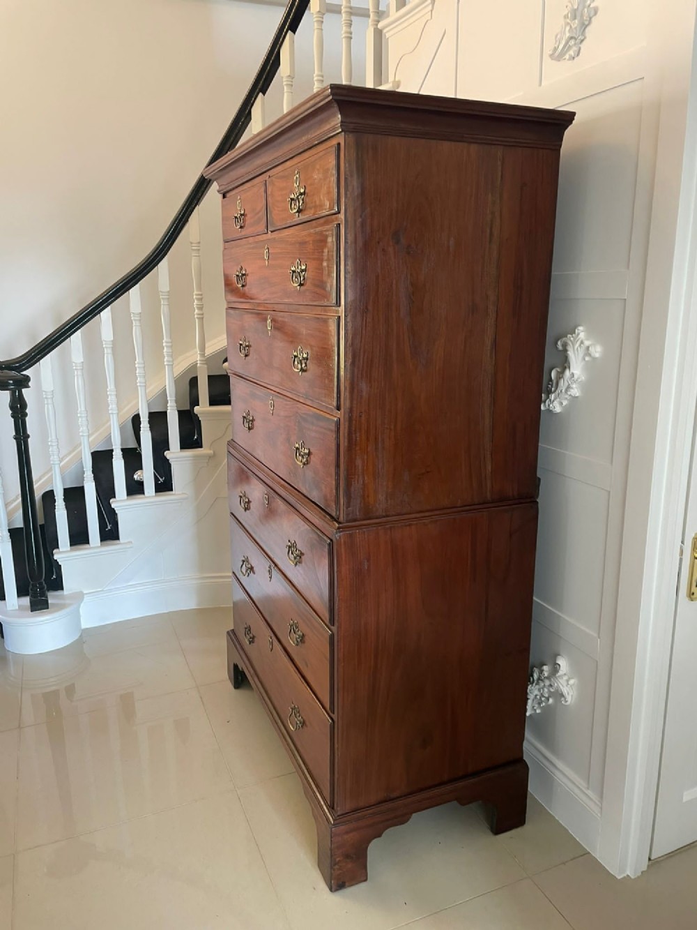 An antique George III mahogany chest on chest featuring two short and three long drawers on the upper section over three long drawers on bracket feet. View XI