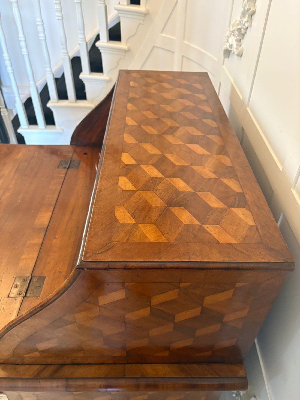 An 18th-century French walnut bureau featuring geometric cubic parquetry inlay, a sloped fall-front lid, curved bombe sides, and brass handles. View III