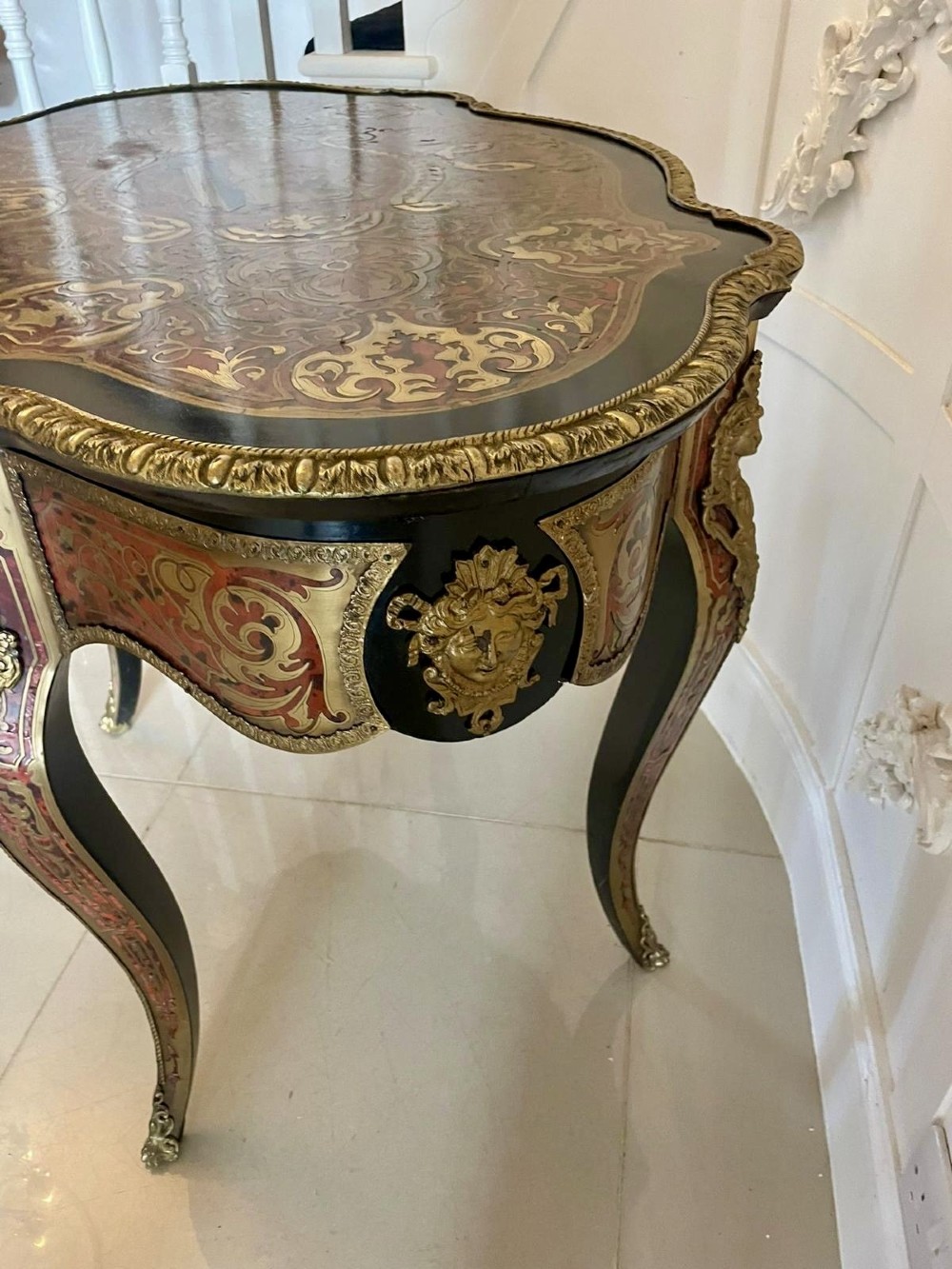 An antique French Louis XV style centre table featuring red tortoiseshell and brass Boulle marquetry, serpentine top, ebonised timber, and cast ormolu mounts on cabriole legs. View III